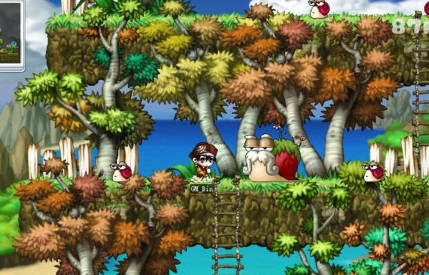 這張圖片來自經典遊戲《楓之谷》（MapleStory），場景位於森林區域，周圍有色彩繽紛的秋季樹木和藍色海洋背景。畫面中可見多隻表情豐富的紅藍蝸牛，中央位置有一隻戴著眼鏡和長鬍子的「蝸牛長老」，是遊戲中的特別NPC。玩家角色「GM_Bin」站在長梯旁，似乎正與蝸牛長老互動。整體畫面充滿童話感，展現了楓之谷世界的可愛風格。