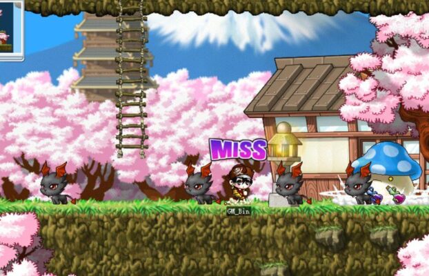 這張圖片來自《楓之谷》（MapleStory），場景設定在日式風格的櫻花村，背景有滿開的櫻花樹、日式建築和一座高塔，營造出濃厚的東洋風情。畫面中央的玩家「GM_Bin」正與多隻黑色小惡魔怪物對戰，角色頭上顯示「MISS」，代表攻擊未命中。右側可見一隻經典的藍色香菇怪和地上掉落的戰利品，畫面整體充滿日系幻想風格。